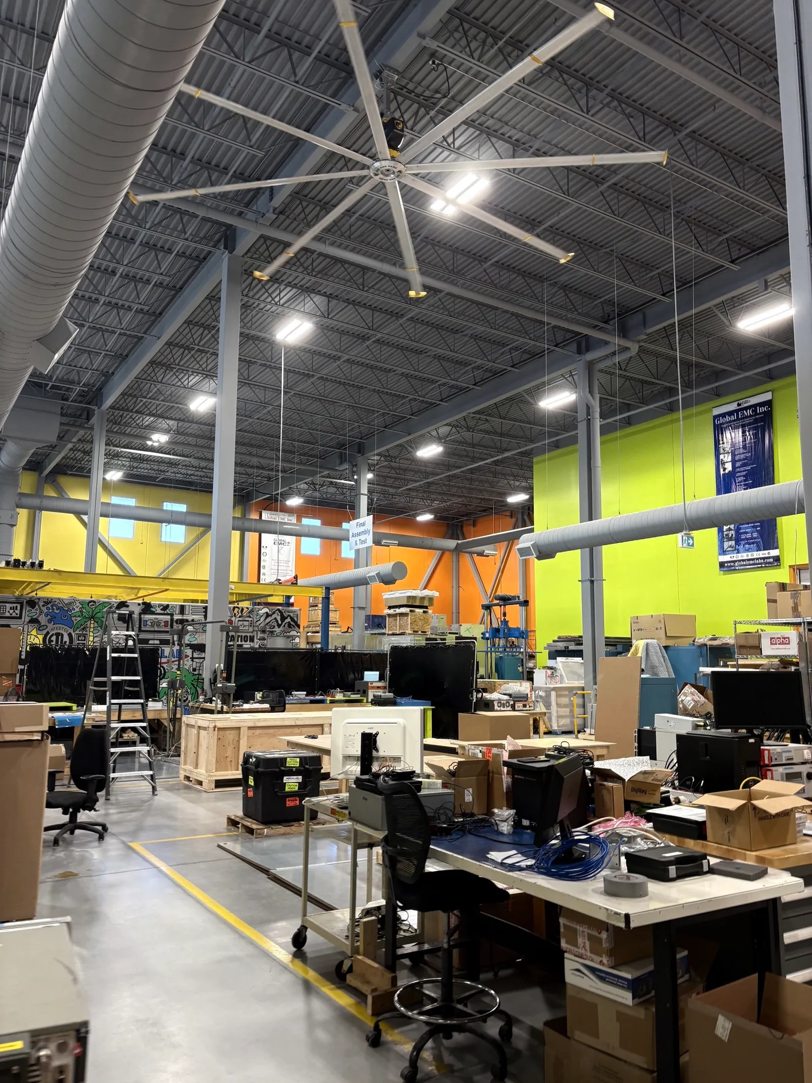 Inside Megalab's testing floor in Aurora, Ontario, with workbenches, test equipment and devices waiting for certification